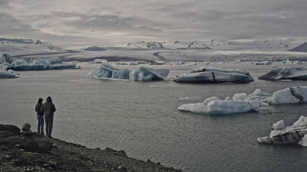 istock Couple hugging and looking at glacier lagoon 1146034456