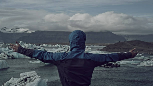 istock Tourist enjoying amazing view. Open arms on glacier lagoon 1146034507