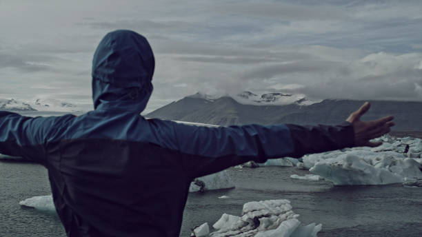 istock Tourist enjoying amazing view. Open arms on glacier lagoon 1146034521