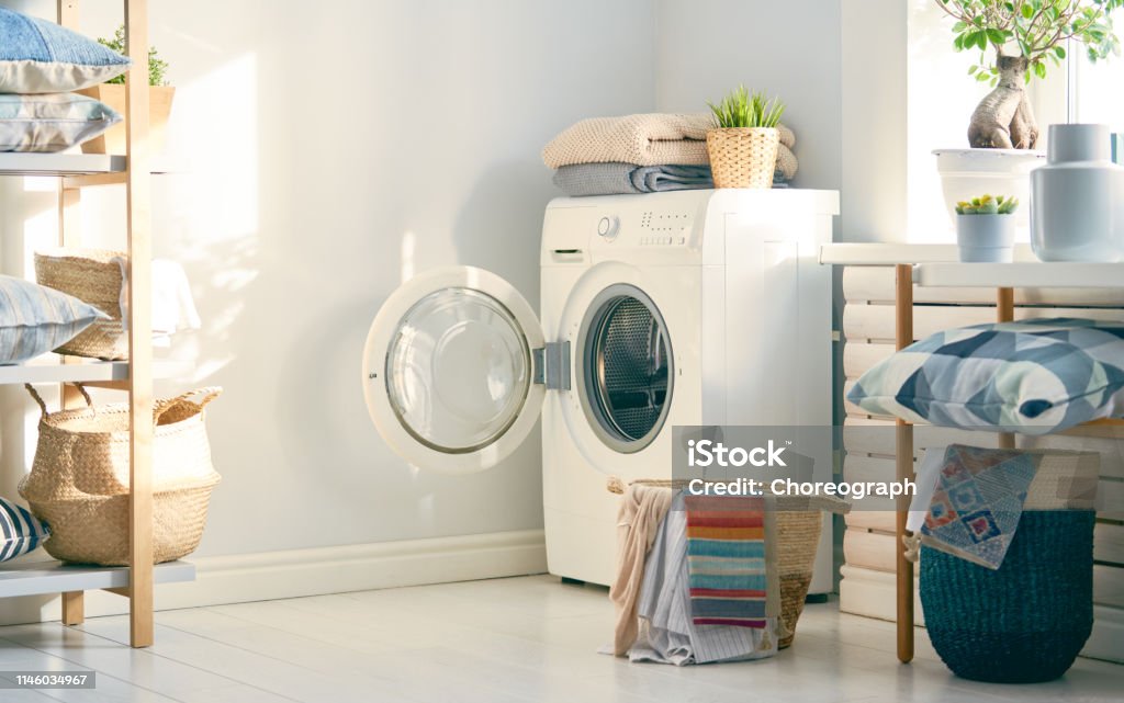 laundry room with a washing machine Interior of a real laundry room with a washing machine at home Washing Machine Stock Photo