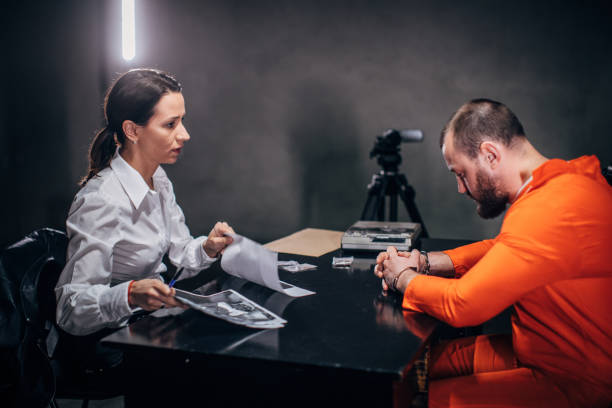 istock Lady detective and prisoner sitting in interrogation room 1146035302