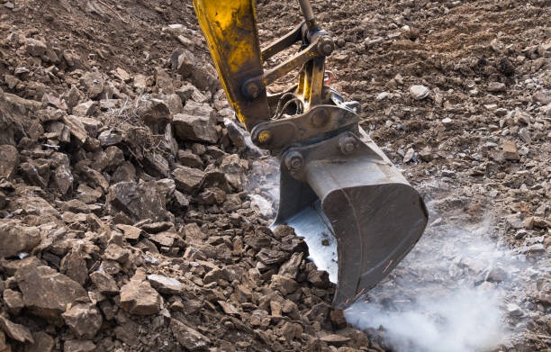istock Working excavator bucket detail. Sparking. Digger machine. Dusty construction site 1146036017
