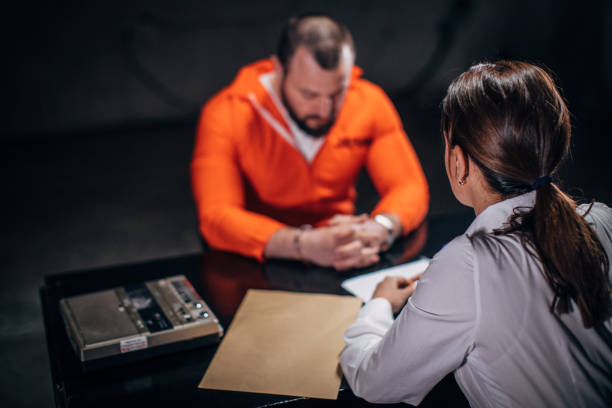istock Lady detective interrogating a man prisoner in interrogation room 1146036198