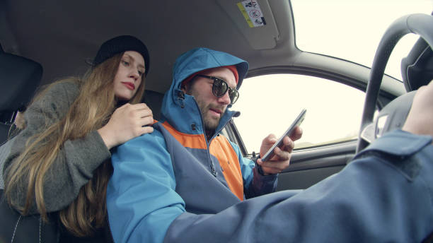 istock Couple on a road trip. Having fun in vehicle interior 1146036510