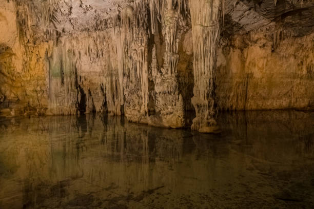 istock Neptune's Grotto (Grotta di Nettuno) a natural stalactite cave near Alghero , Sardinia, Italy. Accessible when the waters are calm by a steep stairway cut into the cliff or by boat from Alghero. 1146036896