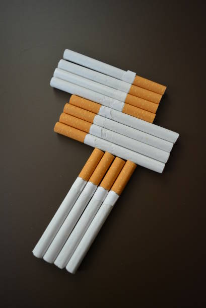 istock New decomposed many cigarettes on a brown matte background. 1146039172