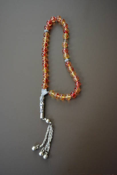 istock Moslem beads from beautiful red yellow beads on a brown matte background. 1146039193