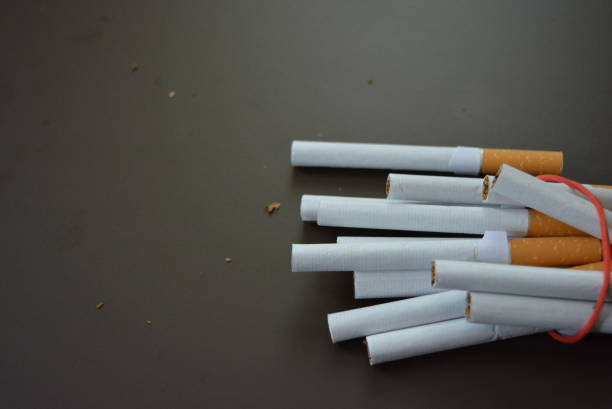 istock New decomposed many cigarettes on a brown matte background. 1146039271
