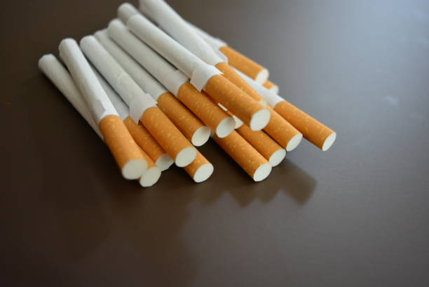 istock New decomposed many cigarettes on a brown matte background. 1146039327