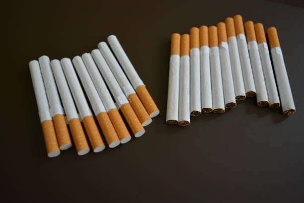 istock New decomposed many cigarettes on a brown matte background. 1146039334