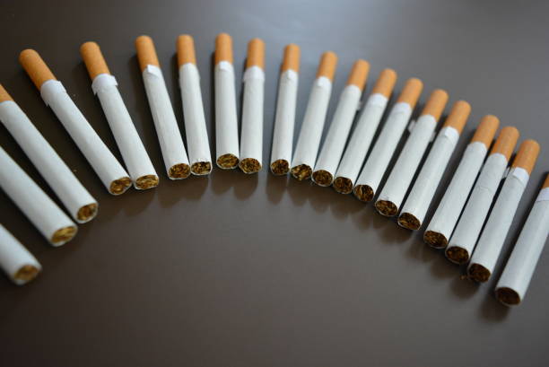 istock New decomposed many cigarettes on a brown matte background. 1146039342