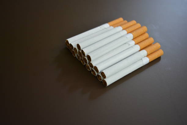 istock New decomposed many cigarettes on a brown matte background. 1146039381
