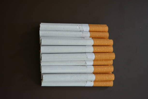 istock New decomposed many cigarettes on a brown matte background. 1146039391