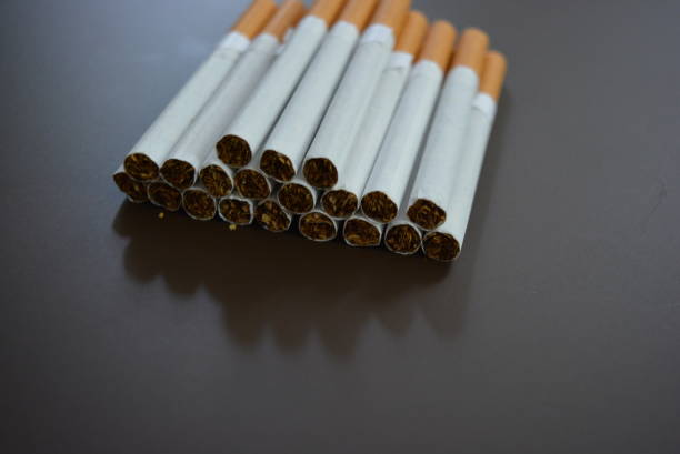 istock New decomposed many cigarettes on a brown matte background. 1146039397