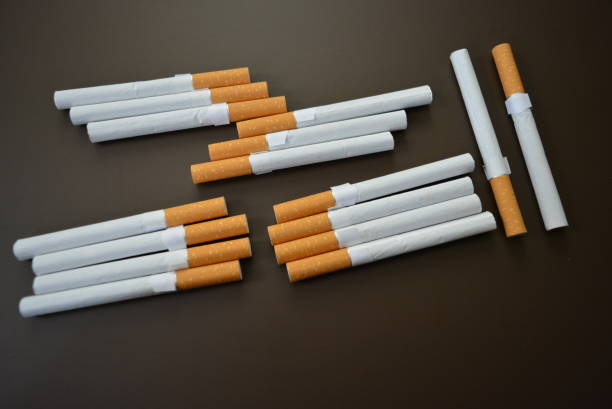 istock New decomposed many cigarettes on a brown matte background. 1146039412