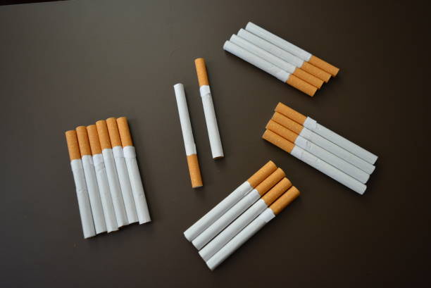 New decomposed many cigarettes on a brown matte background.