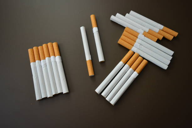 istock New decomposed many cigarettes on a brown matte background. 1146039426
