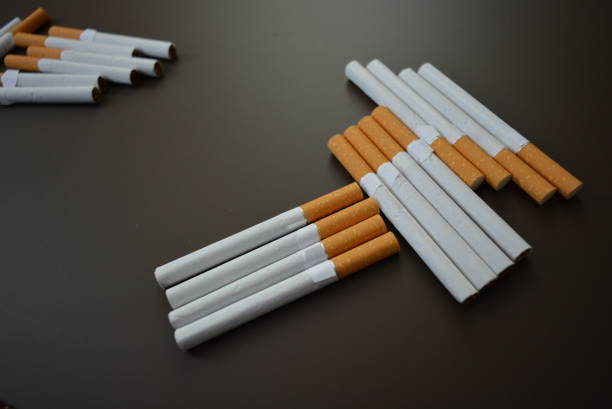 istock New decomposed many cigarettes on a brown matte background. 1146039431
