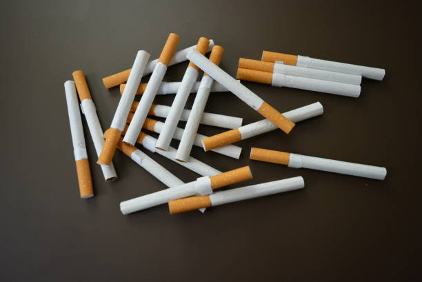 istock New decomposed many cigarettes on a brown matte background. 1146039448