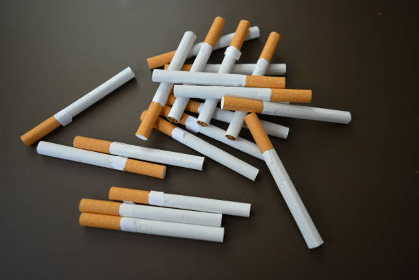 istock New decomposed many cigarettes on a brown matte background. 1146039462