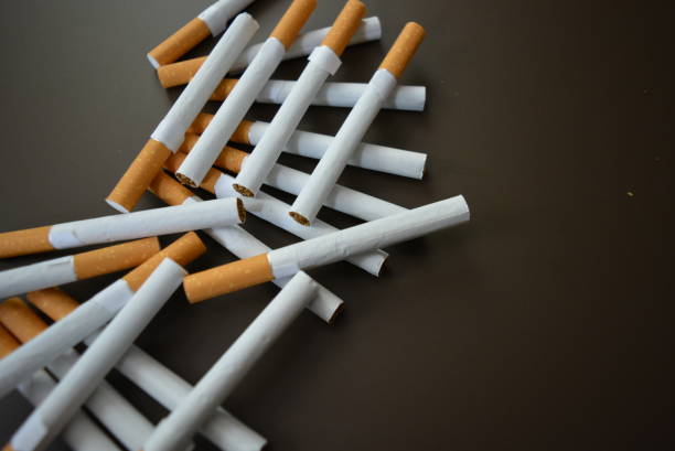 istock New decomposed many cigarettes on a brown matte background. 1146039467