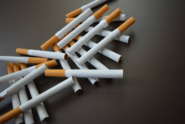 istock New decomposed many cigarettes on a brown matte background. 1146039476