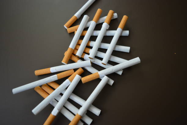 istock New decomposed many cigarettes on a brown matte background. 1146039478