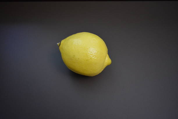 fresh fruit, yellow lemon on an interesting matte background. - lemon fruit portion citrus fruit imagens e fotografias de stock