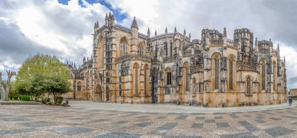 View of the ornate Gothic exterior facade of the Monastery of Batalha, Mosteiro da Batalha, literally the Monastery of the Battle, is a Dominican convent, in Leiria Coimbra / Portugal - 04 04 2019 : View of the ornate Gothic exterior facade of the Monastery of Batalha, Mosteiro da Batalha, literally the Monastery of the Battle, is a Dominican convent, in Leiria, Portugal batalha photos stock pictures, royalty-free photos & images