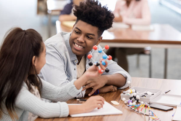 istock Asian American girl shows tutor her molecule 1146044301