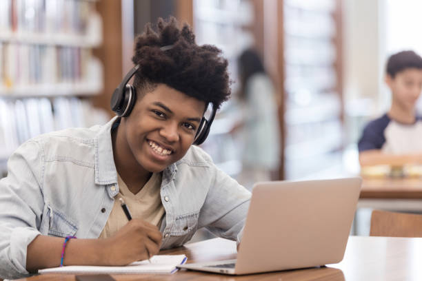 istock Teen looks at camera while working after school 1146044320