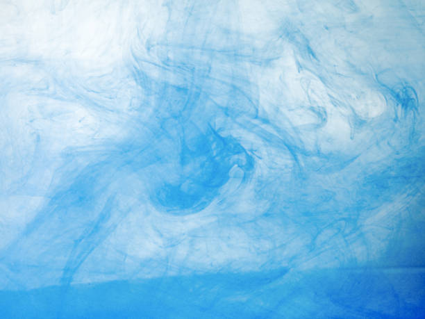istock Blue acrylic ink dissolving into water, close up view. Blurred background. Acrylic light clouds moving in liquid, abstract background. Blue paint mixing with water, abstract pattern. 1146044441