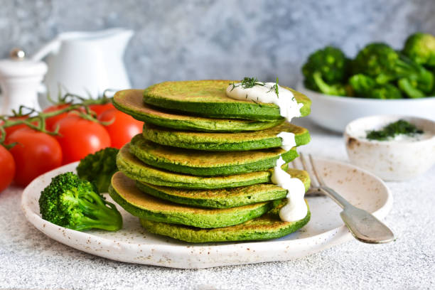 istock Pancakes with broccoli and spinach on the kitchen table. Classic breakfast. 1146044459