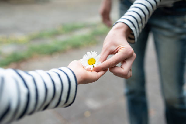 istock Mother and child handing flower 1146045123