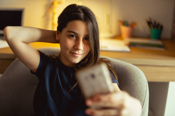 istock Pretty young girl having fun, making selfie with smartphone 1146045449