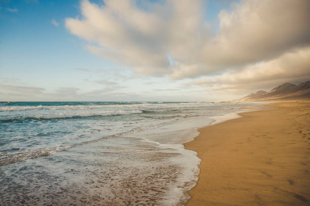 istock Lonely beach with beautiful mountain background  with cloudy sky - summer tropical vacation concept in free sandy scenic place with nobody there 1146047237