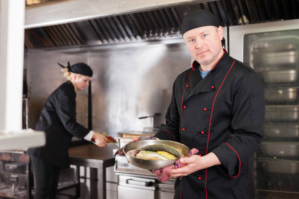 istock Cook offering to taste baked fish 1146049410