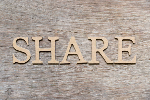istock Alphabet letter in word share on wood background 1146051380