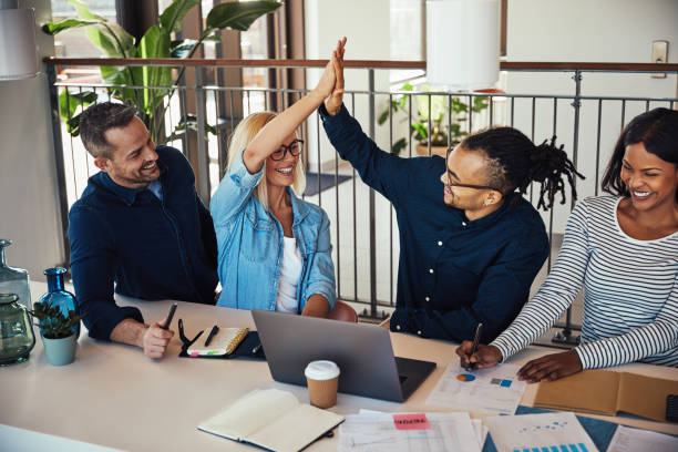 istock Two ecstatic office colleagues high fiving together during a meeting 1146051486