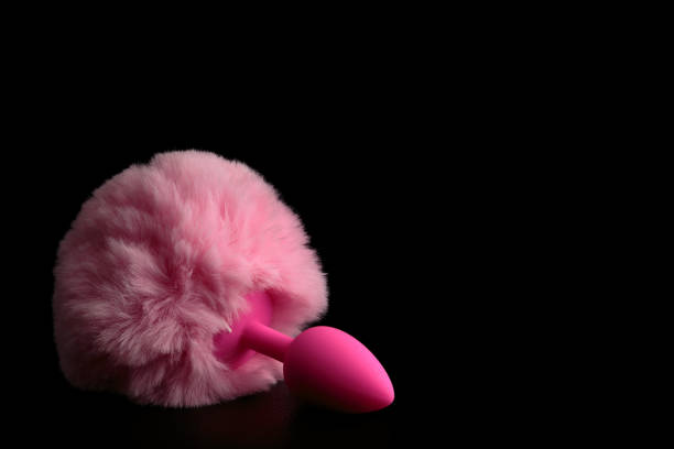 istock Pink anal tail plug isolated on black background. 1146052161