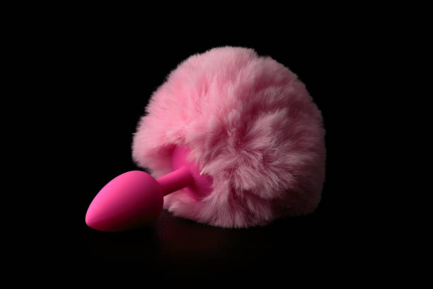 istock Pink anal tail plug isolated on black background. 1146052178