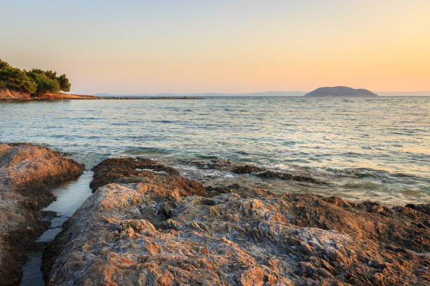istock Distant Turtle island and foreground red rocks in the sea 1146053250
