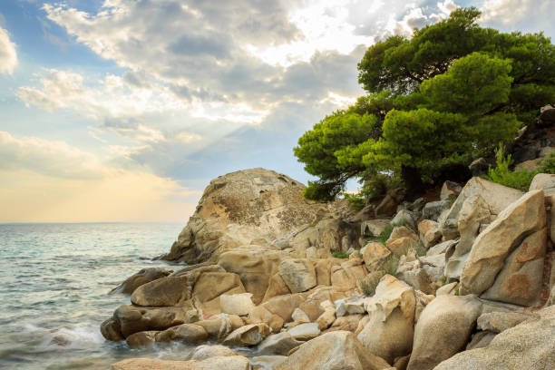 istock Dramatic, colorful sky and rocky edge on a wavy Koviou beach in Greece 1146055850