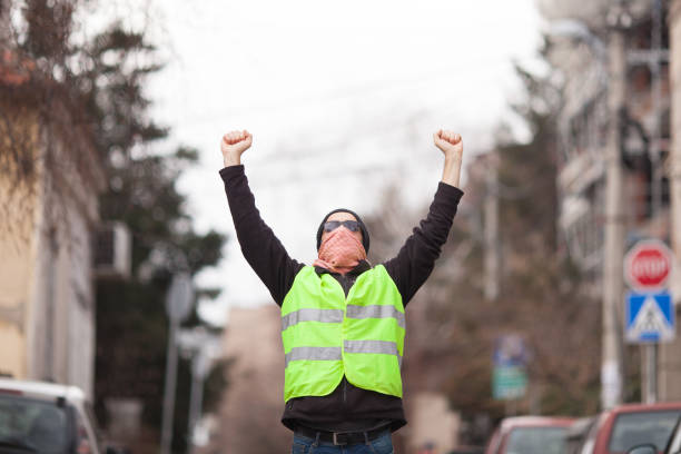 istock yellow vest political activist protesting on street 1146056271