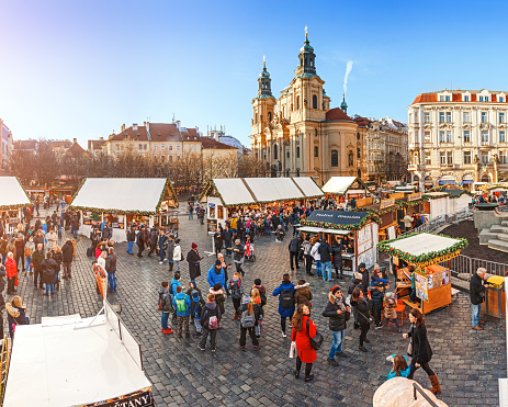 07 December 2017, Prague, Czech Republic: Prague Christmas market on Old Town Square with crowds of tourists and beautiful architecture at the background