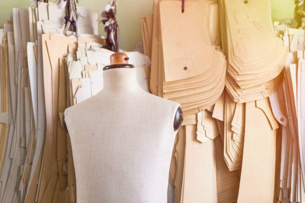 Mannequin in bespoke tailor studio against cardboard sewing patterns. Textile industry. clothing pattern stock pictures, royalty-free photos & images