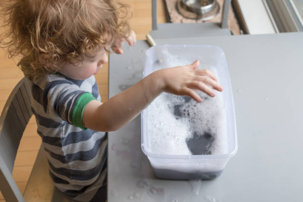 istock A young child plays with water in this learning activity. 1146059525