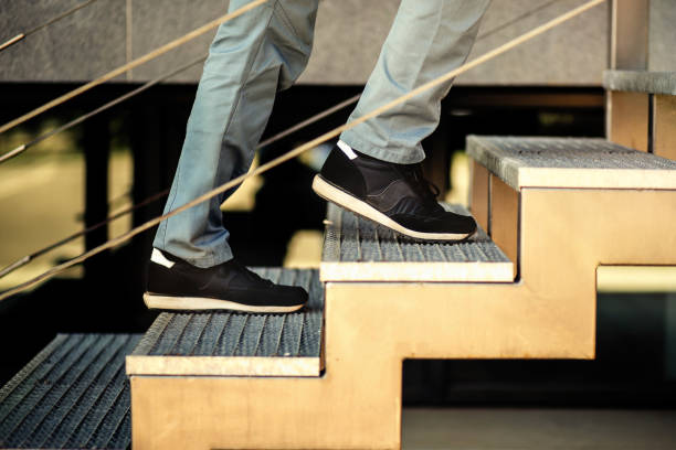Men's feet go up the stairs in side veiw