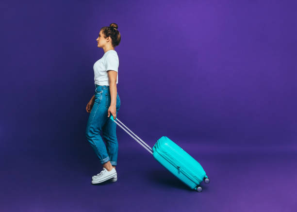 istock Woman with a suitcase Template with copy space 1146064425