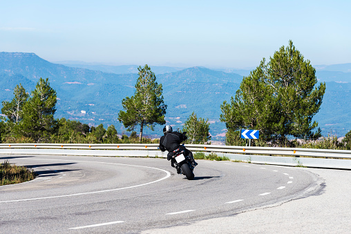 Motorbike entering a curve on a country road in Spain